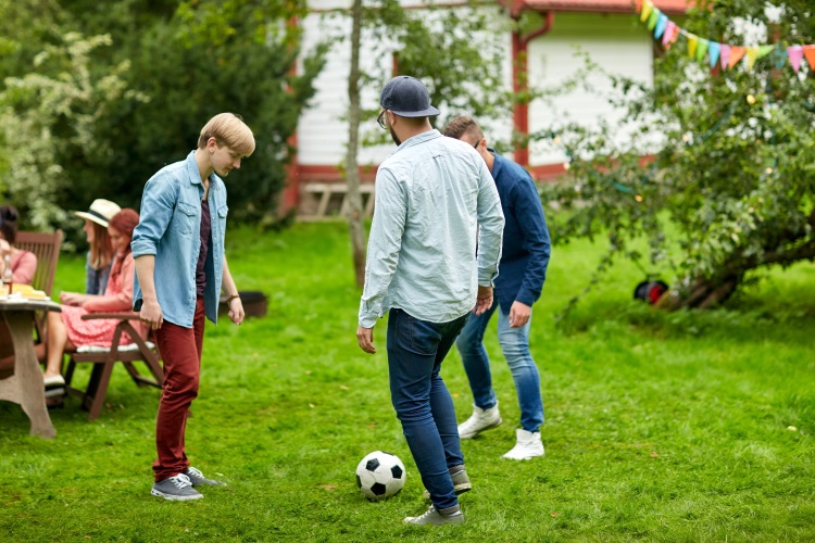 People playing football in garden