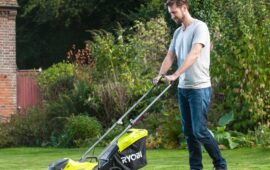 Man using lawnmower in garden